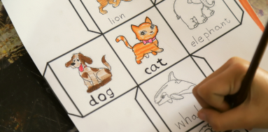 Child coloring in a worksheet